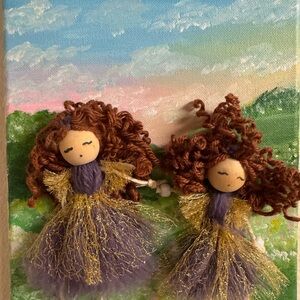 Handcrafted Doll Art with Purple and Gold Dresses